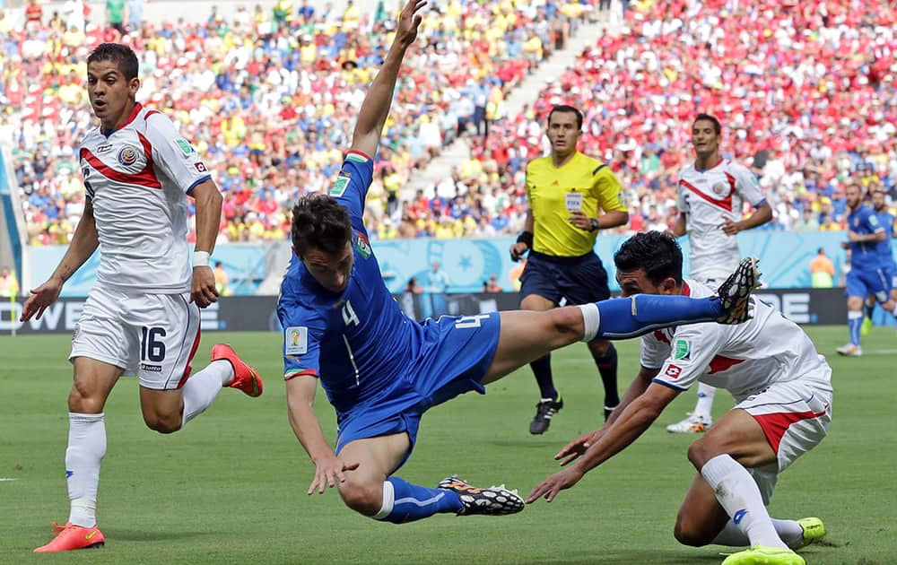 Italy's Matteo Darmian flies through the air after a challenge from Costa Rica's Giancarlo Gonzalez, right, during the group D World Cup soccer match between Italy and Costa Rica at the Arena Pernambuco in Recife, Brazil.