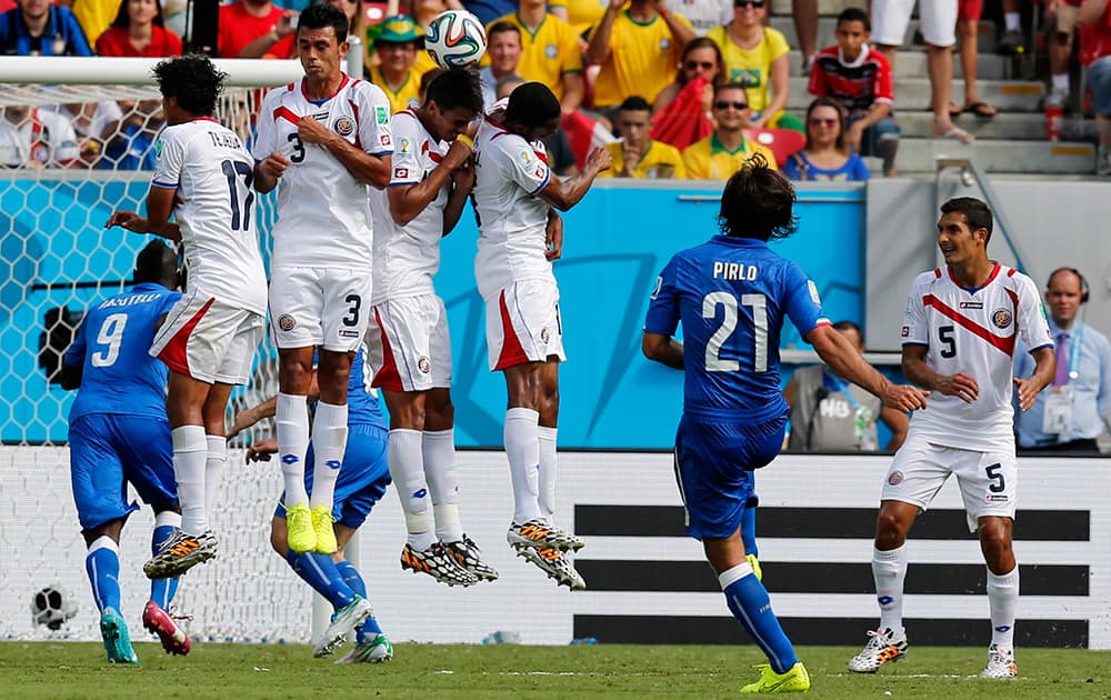 Italy's Andrea Pirlo, second right, takes a free kick during the group D World Cup soccer match between Italy and Costa Rica at the Arena Pernambuco in Recife, Brazil.