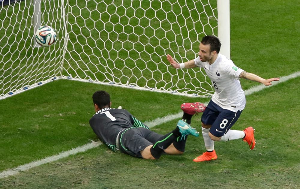 France's Mathieu Valbuena, right, celebrates scoring his side's third goal past Switzerland's goalkeeper Diego Benaglio during the group E World Cup soccer match between Switzerland and France at the Arena Fonte Nova in Salvador, Brazil.