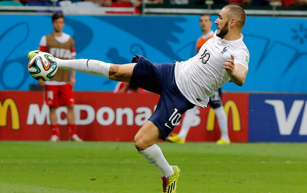 France's Karim Benzema scores his side's fourth goal during the group E World Cup soccer match between Switzerland and France at the Arena Fonte Nova in Salvador.