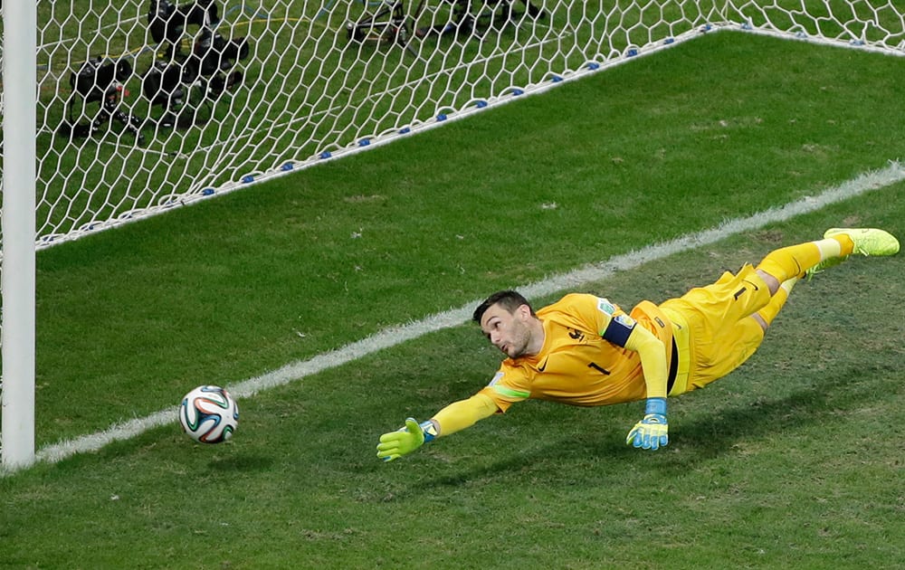 France's goalkeeper Hugo Lloris dives and fails to stop the ball as Switzerland's Blerim Dzemaili scores his side's first goal during the group E World Cup soccer match between Switzerland and France at the Arena Fonte Nova in Salvador, Brazil.