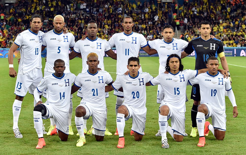 The Honduras team poses for a group photo before the group E World Cup soccer match between Honduras and Ecuador at the Arena da Baixada in Curitiba, Brazil.