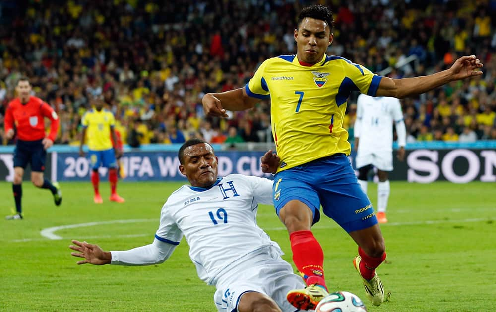 Honduras' Luis Garrido, left, kicks the ball away from Ecuador's Jefferson Montero during the group E World Cup soccer match between Honduras and Ecuador at the Arena da Baixada in Curitiba.