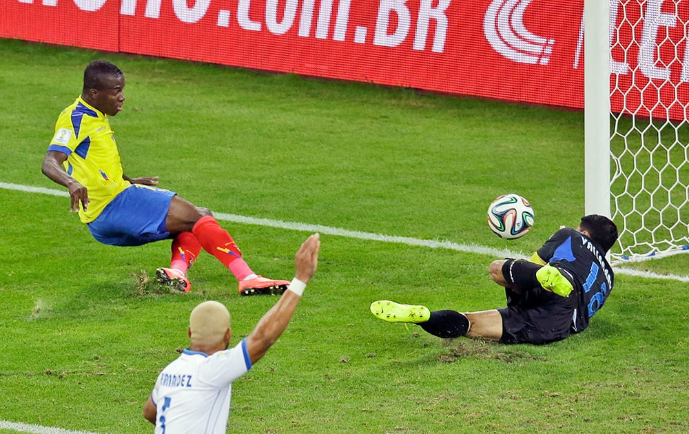 Ecuador's Enner Valencia, left, scores his side's first goal past Honduras' goalkeeper Noel Valladares during the group E World Cup soccer match between Honduras and Ecuador at the Arena da Baixada in Curitiba, Brazil.