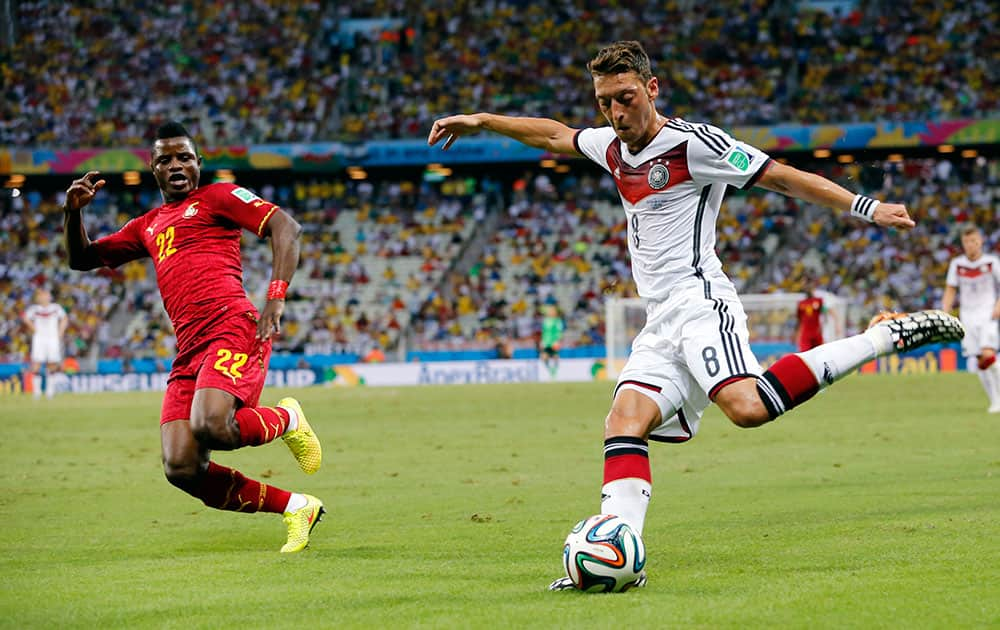 Germany's Mesut Ozil crosses the ball during the group G World Cup soccer match between Germany and Ghana at the Arena Castelao in Fortaleza, Brazil.