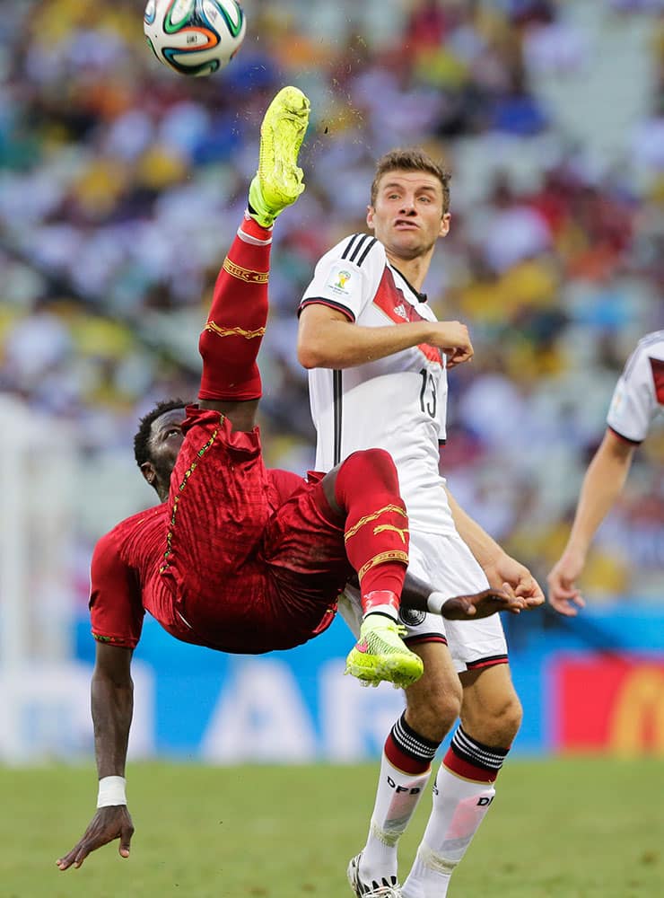 Ghana's Sulley Muntari clears the ball from Germany's Thomas Mueller during the group G World Cup soccer match at the Arena Castelao in Fortaleza, Brazil.