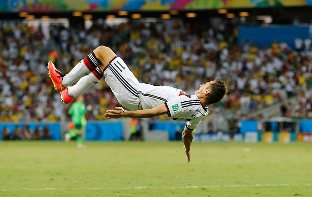 Germany's Miroslav Klose performs a flip as he celebrates after scoring his sides second goal during the group G World Cup soccer match between Germany and Ghana at the Arena Castelao in Fortaleza, Brazil.