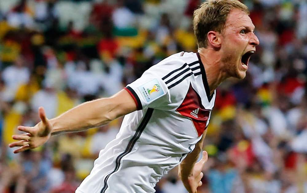 Germany's Benedikt Hoewedes celebrates after his teammate Miroslav Klose scored a goal during the group G World Cup soccer match between Germany and Ghana at the Arena Castelao in Fortaleza, Brazil.