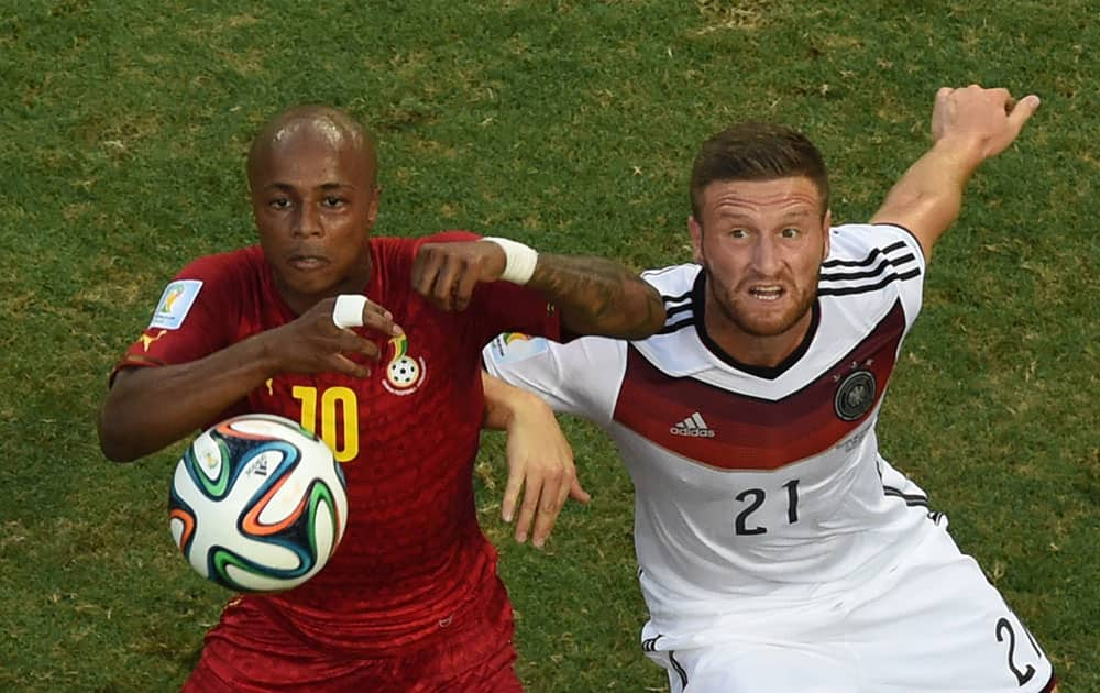 Ghana's Andre Ayew, left, and Germany's Shkodran Mustafi look up at the ball just before Ayew scores his side's first goal during the group G World Cup soccer match between Germany and Ghana at the Arena Castelao in Fortaleza, Brazil.