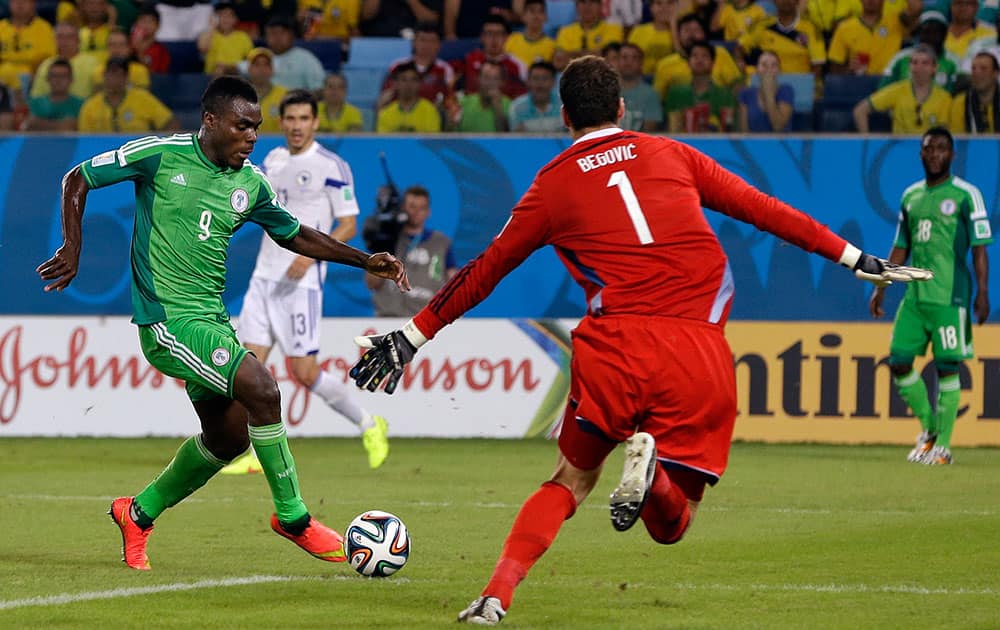 Nigeria's Emmanuel Emenike sets up to shoot on goal against Bosnia's goalkeeper Asmir Begovic during the group F World Cup soccer match between Nigeria and Bosnia at the Arena Pantanal in Cuiaba, Brazil.