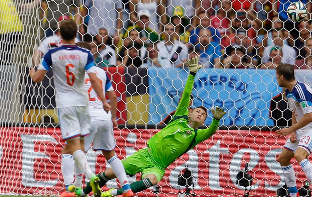 Russia's goalkeeper Igor Akinfeev can't stop a shot by Belgium's Divock Origi to score his side's first goal during the group H World Cup soccer match between Belgium and Russia at the Maracana Stadium in Rio de Janeiro, Brazil.