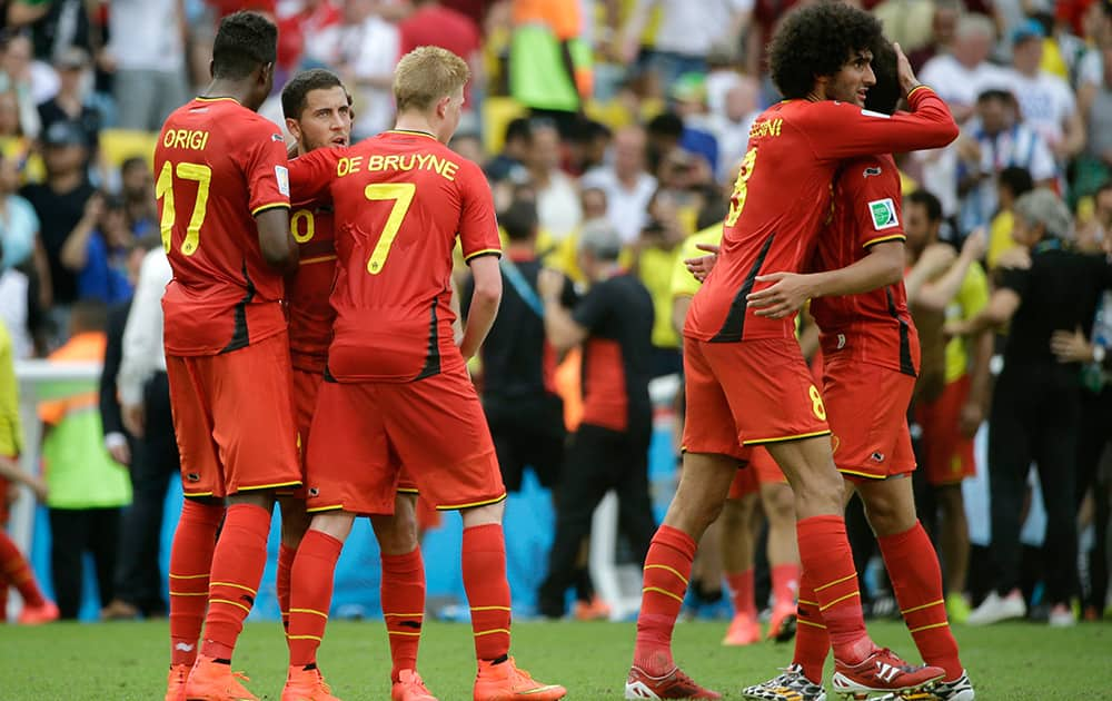 Belgian players greet each other after the group H World Cup soccer match between Belgium and Russia at the Maracana Stadium in Rio de Janeiro, Brazil. Belgium won the match 1-0.