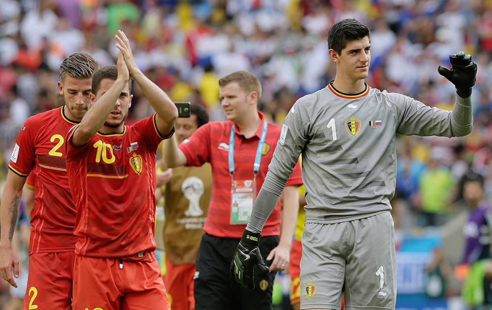 Belgium's goalkeeper Thibaut Courtois (1) and Belgium's Eden Hazard (10) wave to spectators following Belgium's 1-0 victory over Russia during the group H World Cup soccer match between Belgium and Russia at the Maracana Stadium in Rio de Janeiro, Brazil.