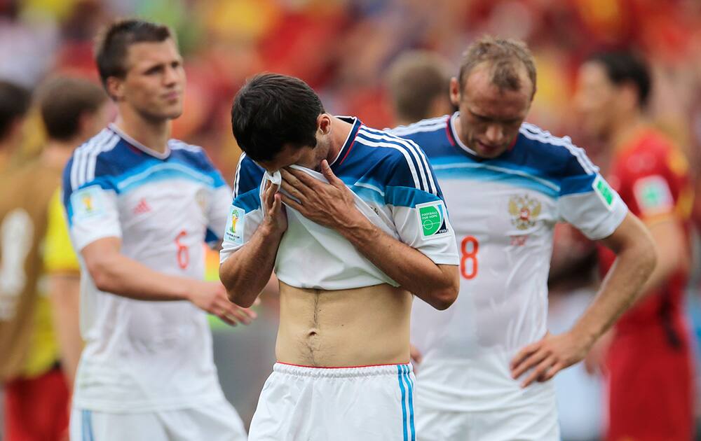 Russia's Alan Dzagoev, center, reacts after the group H World Cup soccer match between Belgium and Russia at the Maracana Stadium in Rio de Janeiro, Brazil.