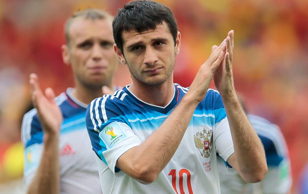 Russia's Alan Dzagoev applauds the crowd after the group H World Cup soccer match between Belgium and Russia at the Maracana Stadium in Rio de Janeiro, Brazil. Belgium won the match 1-0.