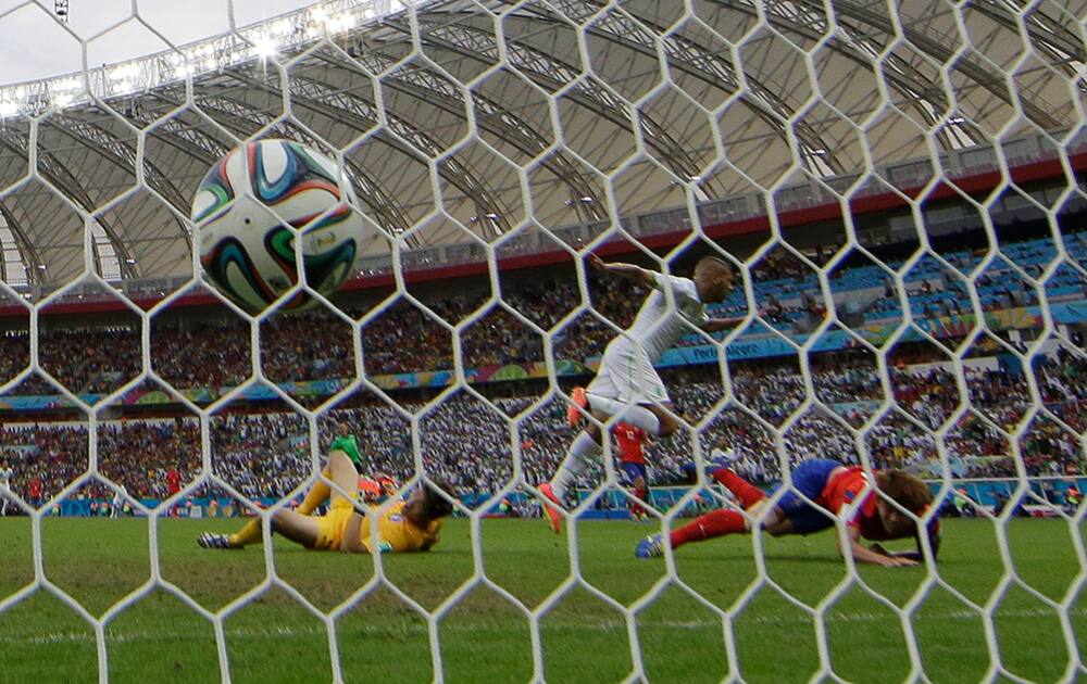 Algeria's Islam Slimani scores the opening goal during the group H World Cup soccer match between South Korea and Algeria at the Estadio Beira-Rio in Porto Alegre, Brazil.