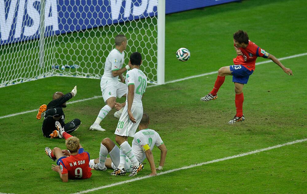 South Korea's Koo Ja-cheol shoots and scores his side's second goal during the group H World Cup soccer match between South Korea and Algeria at the Estadio Beira-Rio in Porto Alegre, Brazil.