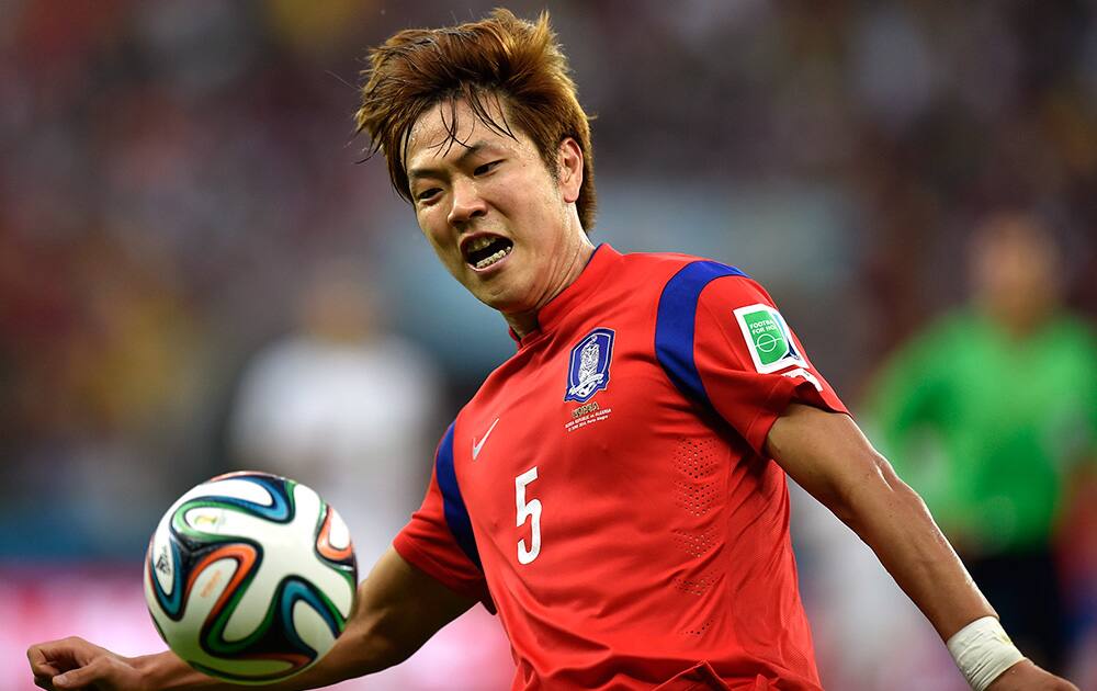 South Korea's Kim Young-gwon kicks the ball during the group H World Cup soccer match between South Korea and Algeria at the Estadio Beira-Rio in Porto Alegre, Brazil.