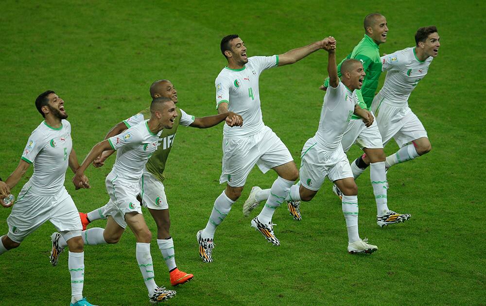 Members of the Algerian soccer team join hands as they celebrate winning 4-2 after the group H World Cup soccer match between South Korea and Algeria at the Estadio Beira-Rio in Porto Alegre, Brazil.