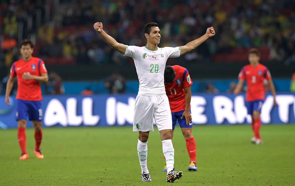 Algeria's Aissa Mandi celebrates after Algeria's 4-2 victory over South Korea during the group H World Cup soccer match between South Korea and Algeria at the Estadio Beira-Rio in Porto Alegre, Brazil.