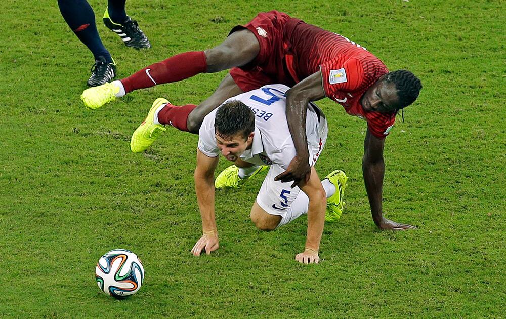 United States' Matt Besler and Portugal's Eder challenge for the ball during the group G World Cup soccer match between the USA and Portugal at the Arena da Amazonia in Manaus, Brazil.