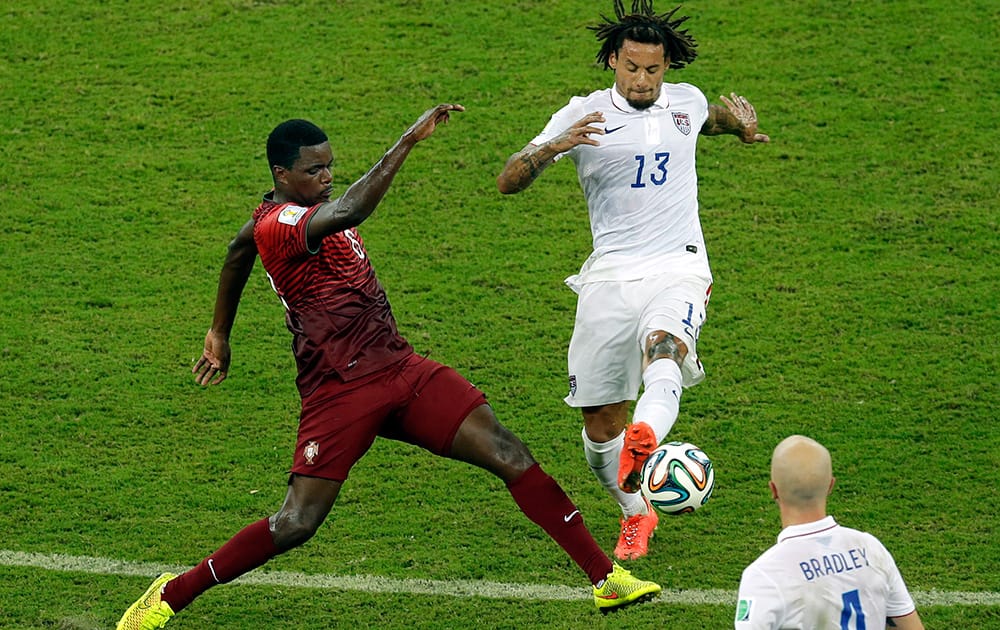 Portugal's William Carvalho, left, and United States' Jermaine Jones challenge for the ball during the group G World Cup soccer match between the USA and Portugal at the Arena da Amazonia in Manaus, Brazil.