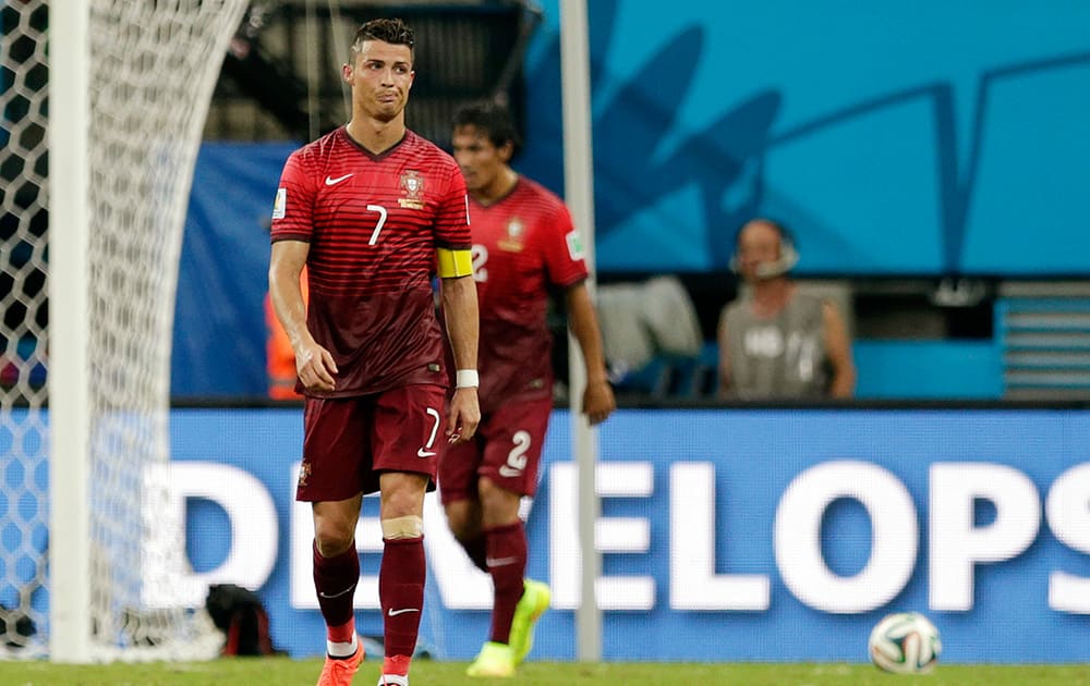 Portugal's Cristiano Ronaldo walks back to mid-field after missing a shot on goal during the group G World Cup soccer match between the United States and Portugal at the Arena da Amazonia in Manaus, Brazil. The United States and Portugal tied 2-2.