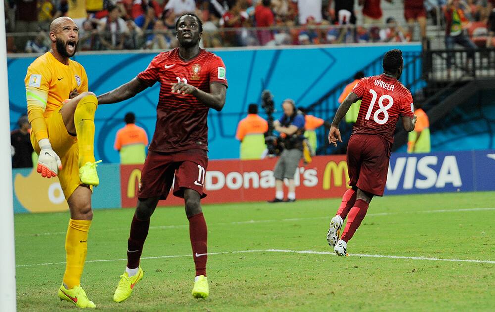 United States' goalkeeper Tim Howard stands near the post as he reacts next to Portugal's Eder, second from left, after Portugal's Silvestre Varela, right, scored the equaliser during the group G World Cup soccer match between the USA and Portugal at the Arena da Amazonia in Manaus, Brazil.