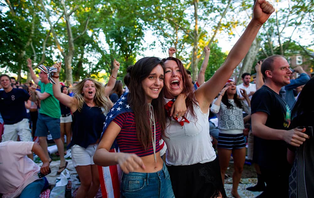 Allison DiFilippo, left, and Samantha Donat, both of New York, react as the United States went up 2-1 over Portugal in the second half as they watched the 2014 World Cup Group G soccer match at a large screen public broadcast on Governor's Island in New York.