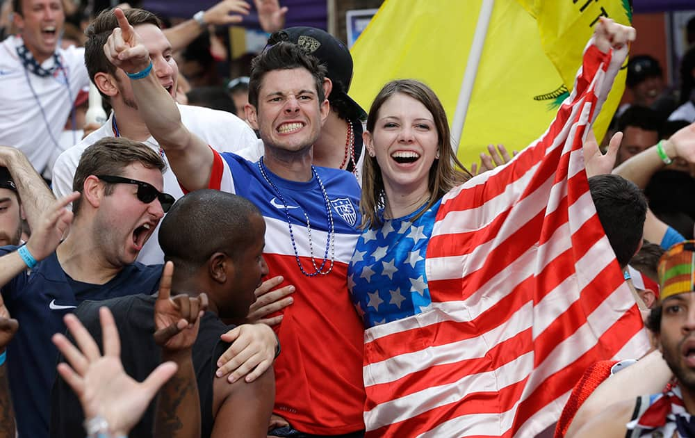 Fans celebrate as the United States scores a goal against Portugal while watching a World Cup soccer match in Orlando, Fla.