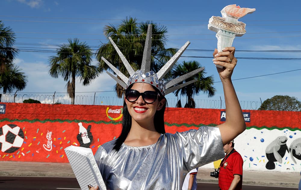 A fan dressed as the Statue of Liberty arrives for the group G World Cup soccer match between the USA and Portugal at the Arena da Amazonia in Manaus, Brazil.