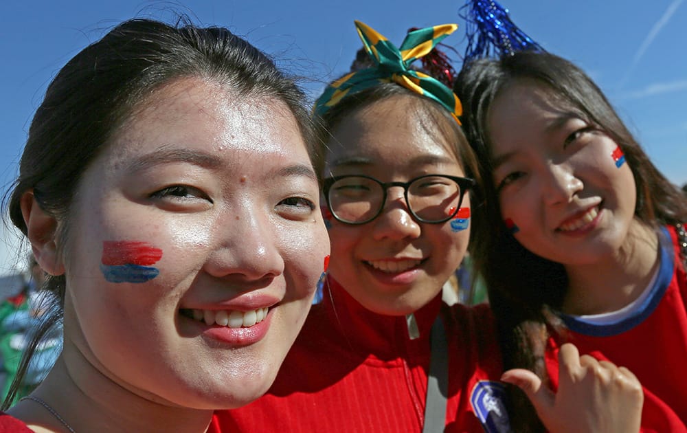 South Korean fans pose outside of Estadio Beira-Rio before the group H World Cup soccer match between South Korea and Algeria in Porto Alegre, Brazil.