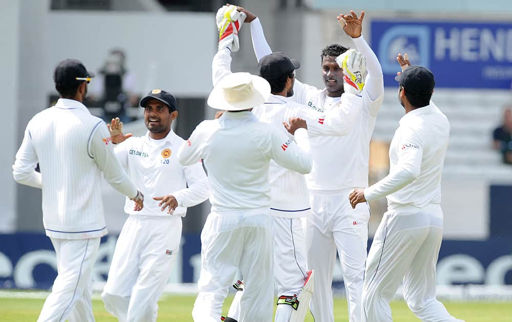 Sri Lanka's captain Angelo Mathews celebrates with teammates after England's Stuart Broad was caught by Lahiru Thirimanne for 4 runs, during day three of the Second Test Match between England and Sri Lanka at Headingley cricket ground, Leeds, England.