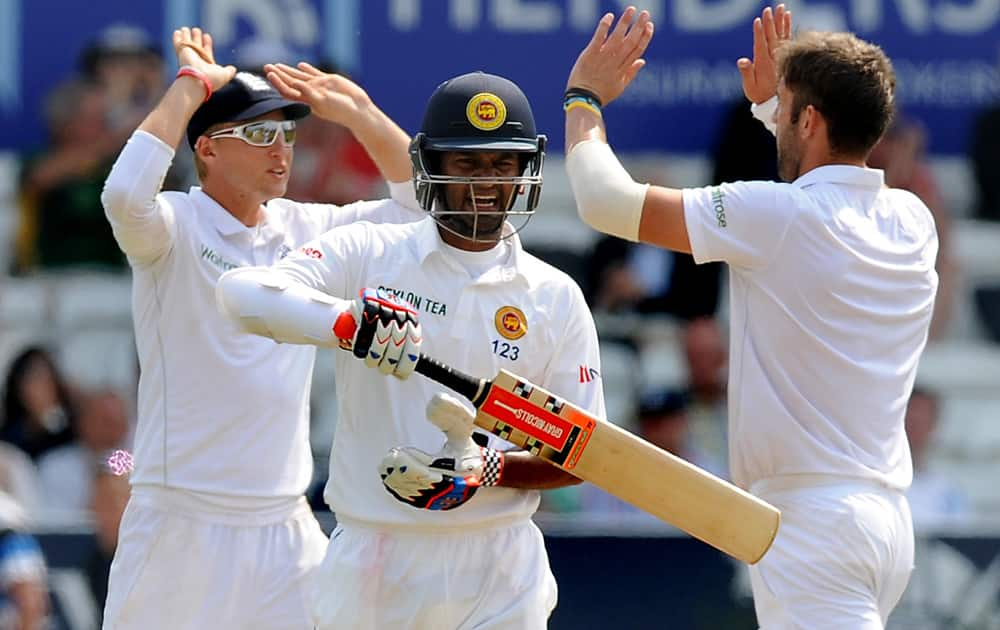 England's Liam Plunkett and Joe Root celebrate as Sri Lanka's Dimuth Karunaratne is bowled by England's Liam Plunkett caught Matt Prior for 45 runs, during day three of the Second Test Match between England and Sri Lanka at Headingley cricket ground, Leeds, England.