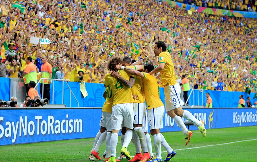 Brazil celebrate after Brazil's Neymar's first goal during the group A World Cup soccer match between Cameroon and Brazil at the Estadio Nacional in Brasilia, Brazil.