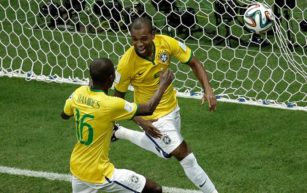 Brazil's Fernandinho, right, celebrates scoring his side's 5th goal during the group A World Cup soccer match between Cameroon and Brazil at the Estadio Nacional in Brasilia, Brazil.