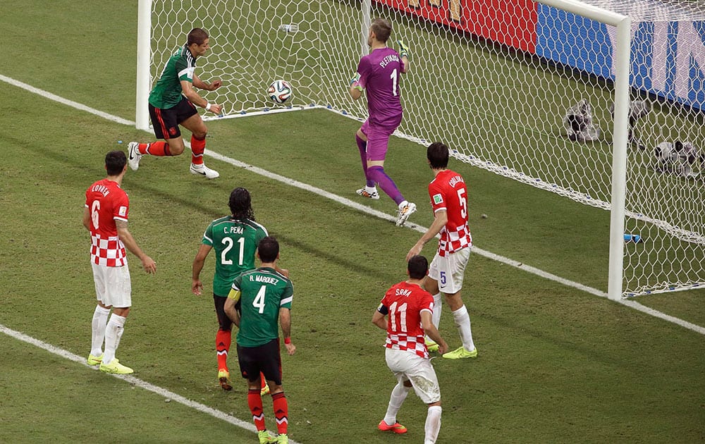 Mexico's Javier Hernandez (14) celebrates scoring his side's 3rd goal during the group A World Cup soccer match between Croatia and Mexico at the Arena Pernambuco in Recife, Brazil.