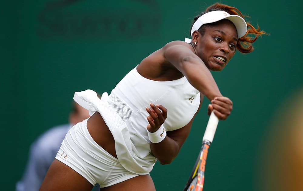 Sloane Stephens of the US serves to Russia's Maria Kirilenko during their first round match at the All England Lawn Tennis Championships in Wimbledon, London.