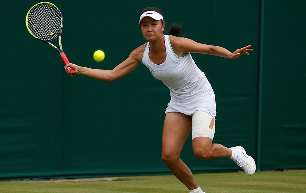 Peng Shuai of China plays a return to Johanna Konta of Britain during their first round match at the All England Lawn Tennis Championships in Wimbledon, London.