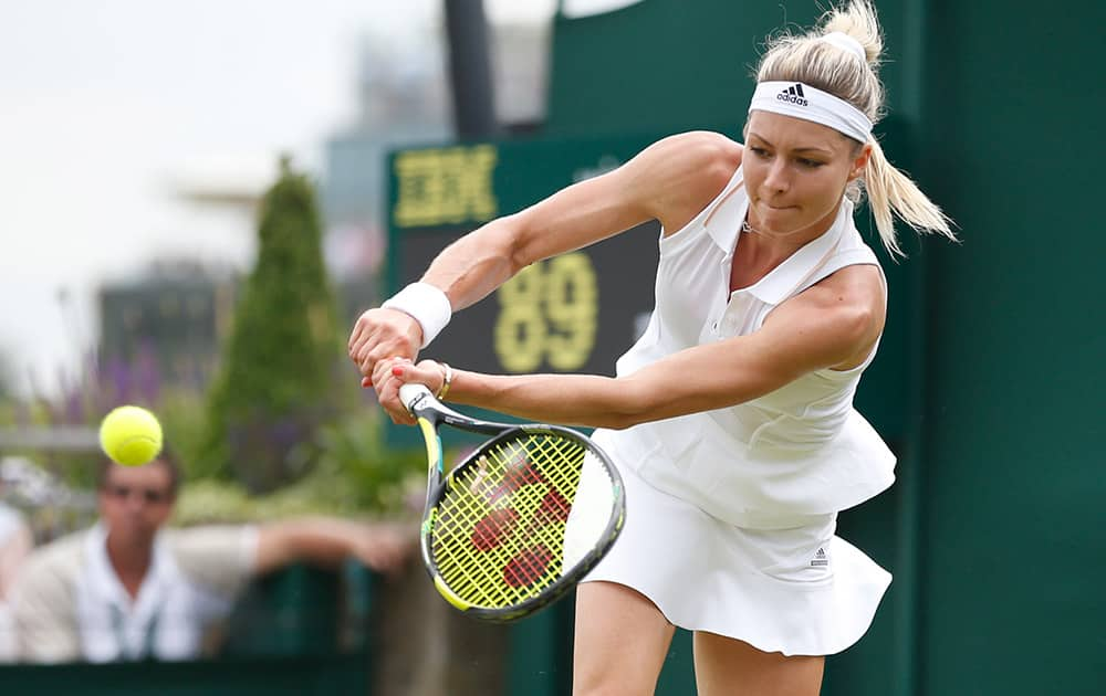 Maria Kirilenko of Russia plays a return to Sloane Stephens of US during their first round match at the All England Lawn Tennis Championships in Wimbledon, London.