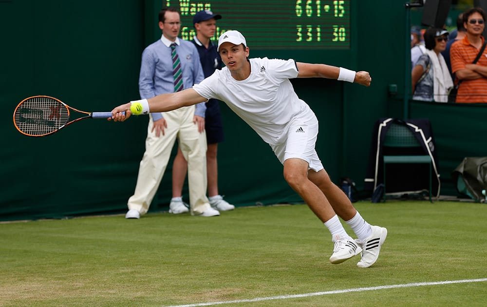 Alejandro Gonzalez of Colombia returns against Jimmy Wang of Chinese Taipei during their first round match at the All England Lawn Tennis Championships in Wimbledon, London.