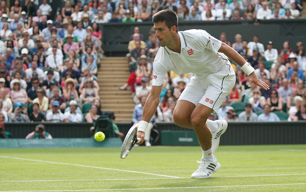 Novak Djokovic of Serbia plays a return to Andrey Golubev of Kazakhstan during their first round match at the All England Lawn Tennis Championships in Wimbledon.