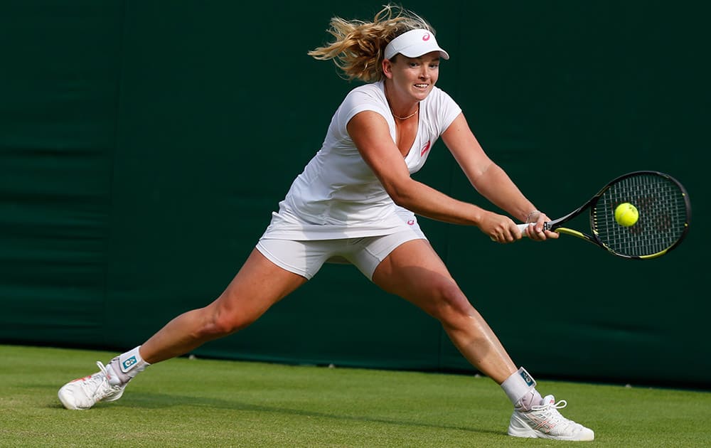 Coco Vandeweghe of the US plays a return to Garbine Muguruza of Spain during their first round match at the All England Lawn Tennis Championships in Wimbledon, London.