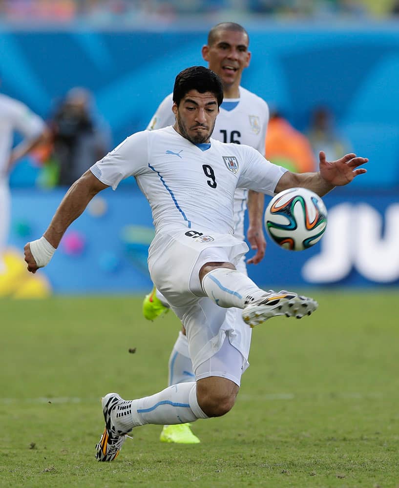 Uruguay's Luis Suarez kicks the ball during the group D World Cup soccer match against Italy at the Arena das Dunas in Natal, Brazil.