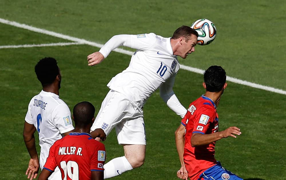 England's Wayne Rooney heads the ball during the group D World Cup soccer match between Costa Rica and England at the Mineirao Stadium in Belo Horizonte, Brazil.