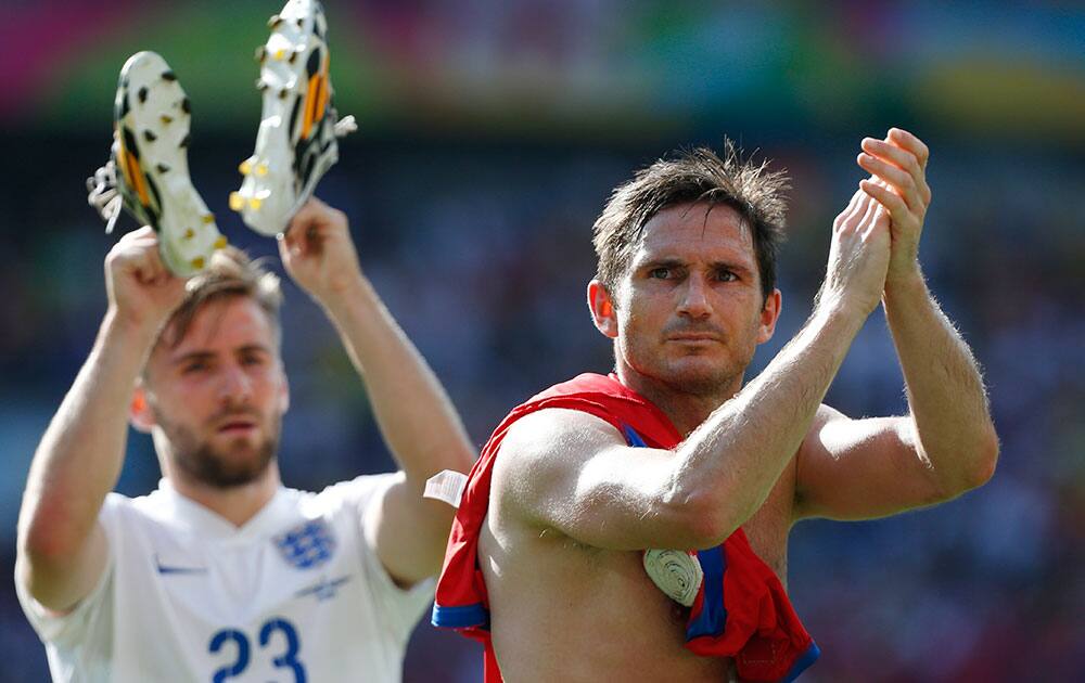 England's Frank Lampard, right, and England's Luke Shaw greet England fans after the group D World Cup soccer match between Costa Rica and England at the Mineirao Stadium in Belo Horizonte, Brazil.