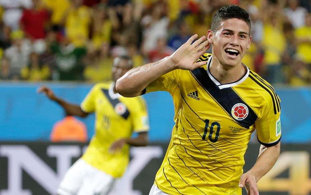 Colombia's James Rodriguez celebrates after scoring his side's fourth goal during the group C World Cup soccer match between Japan and Colombia at the Arena Pantanal in Cuiaba, Brazil.