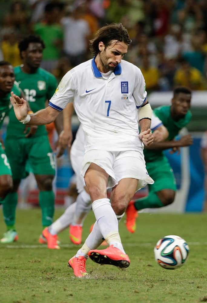 Greece's Giorgos Samaras scores his side's 2nd goal from the penalty spot during the group C World Cup soccer match between Greece and Ivory Coast at the Arena Castelao in Fortaleza, Brazil.