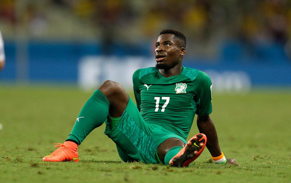 Ivory Coast's Serge Aurier sits on the ground after losing 1-2 in the group C World Cup soccer match between Greece and Ivory Coast at the Arena Castelao in Fortaleza, Brazil.