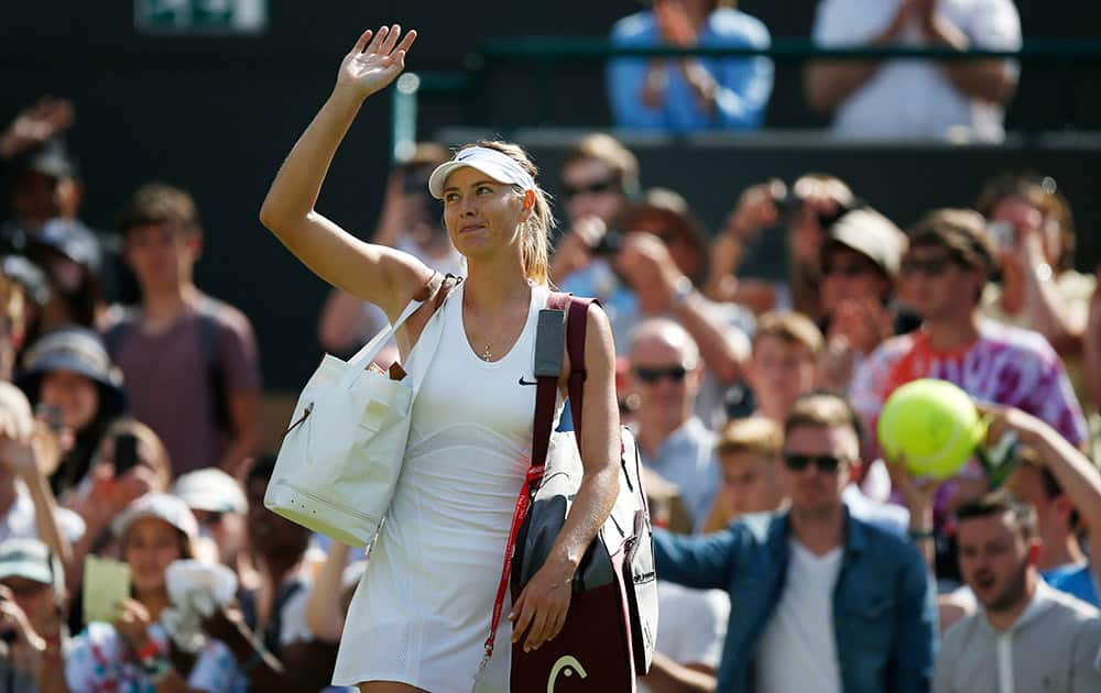 Maria Sharapova of Russia waves after winning against Samantha Murray of Britain during their first round match at the All England Lawn Tennis Championships in Wimbledon.